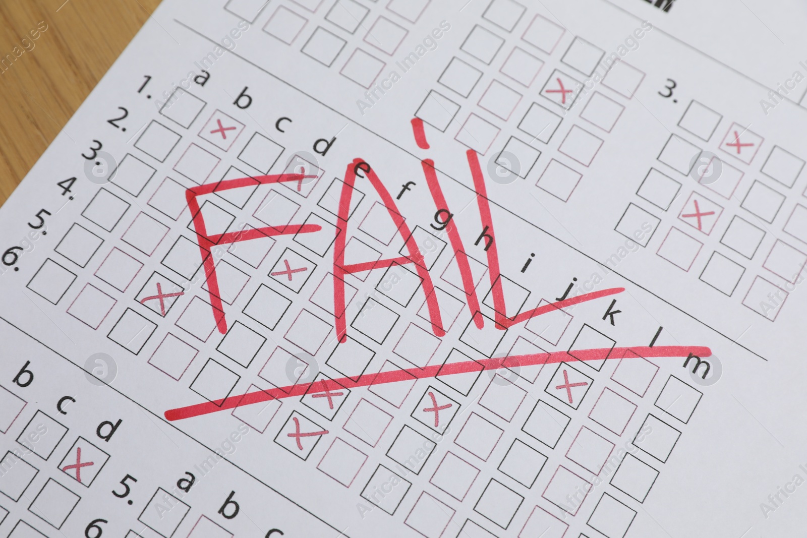 Photo of Answer sheet with word Fail on table, closeup. Student passing exam