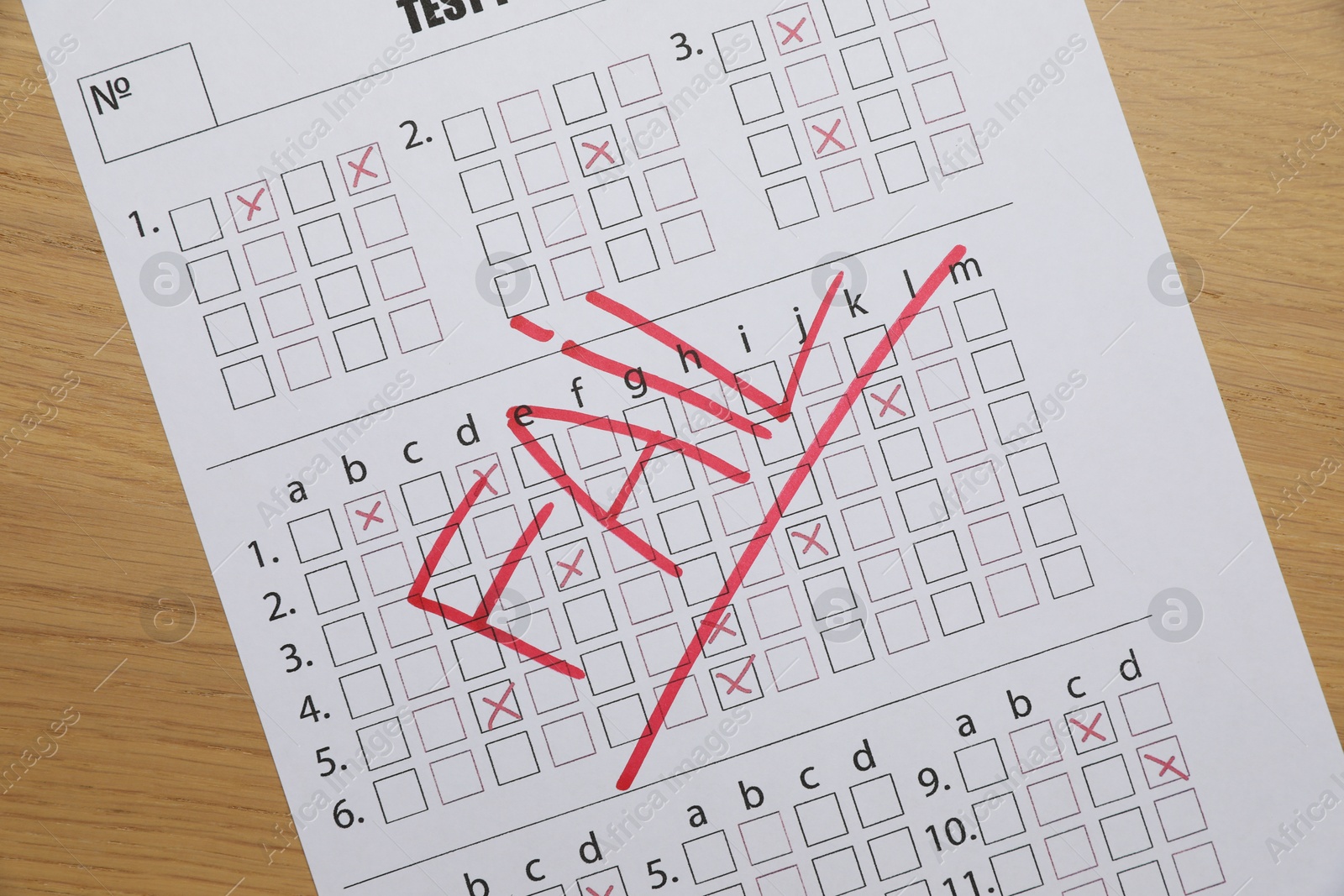 Photo of Answer sheet with word Fail on wooden table, top view. Student passing exam