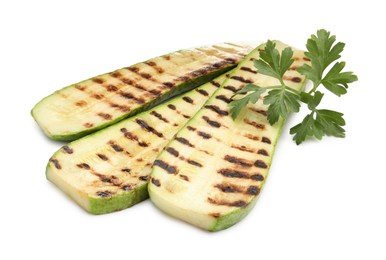 Photo of Delicious grilled courgette slices and parsley isolated on white
