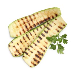 Photo of Delicious grilled courgette slices and parsley isolated on white, top view