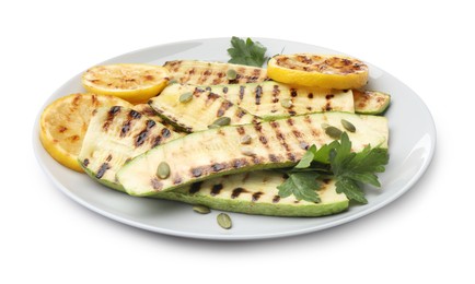 Photo of Delicious grilled courgette slices with pumpkin seeds, lemon and parsley isolated on white