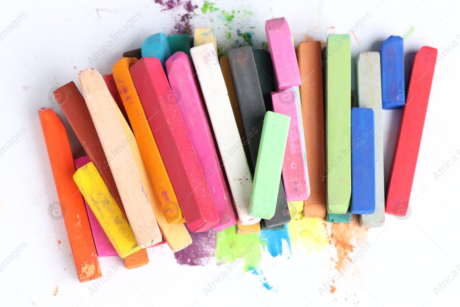 Photo of Many colorful chalk pastels on white background, top view