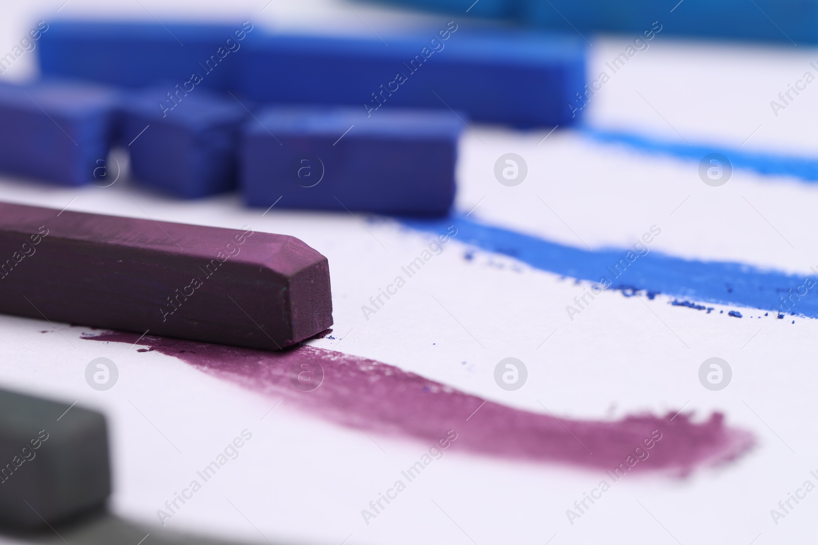Colorful chalk pastels on white background, closeup Photo of Colorful chalk pastels on white background, closeup