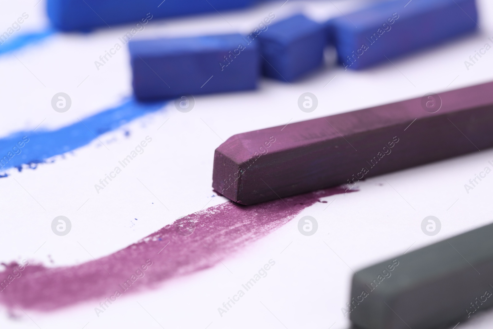 Colorful chalk pastels on white background, closeup Photo of Colorful chalk pastels on white background, closeup