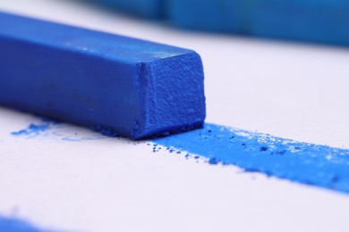 Photo of Colorful chalk pastels on white background, closeup