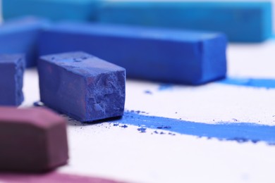 Photo of Colorful chalk pastels on white background, closeup