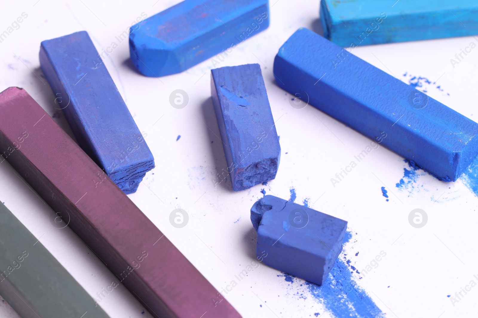 Colorful chalk pastels on white background, closeup Photo of Colorful chalk pastels on white background, closeup
