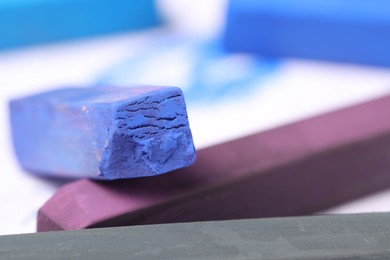 Photo of Colorful chalk pastels on white background, closeup