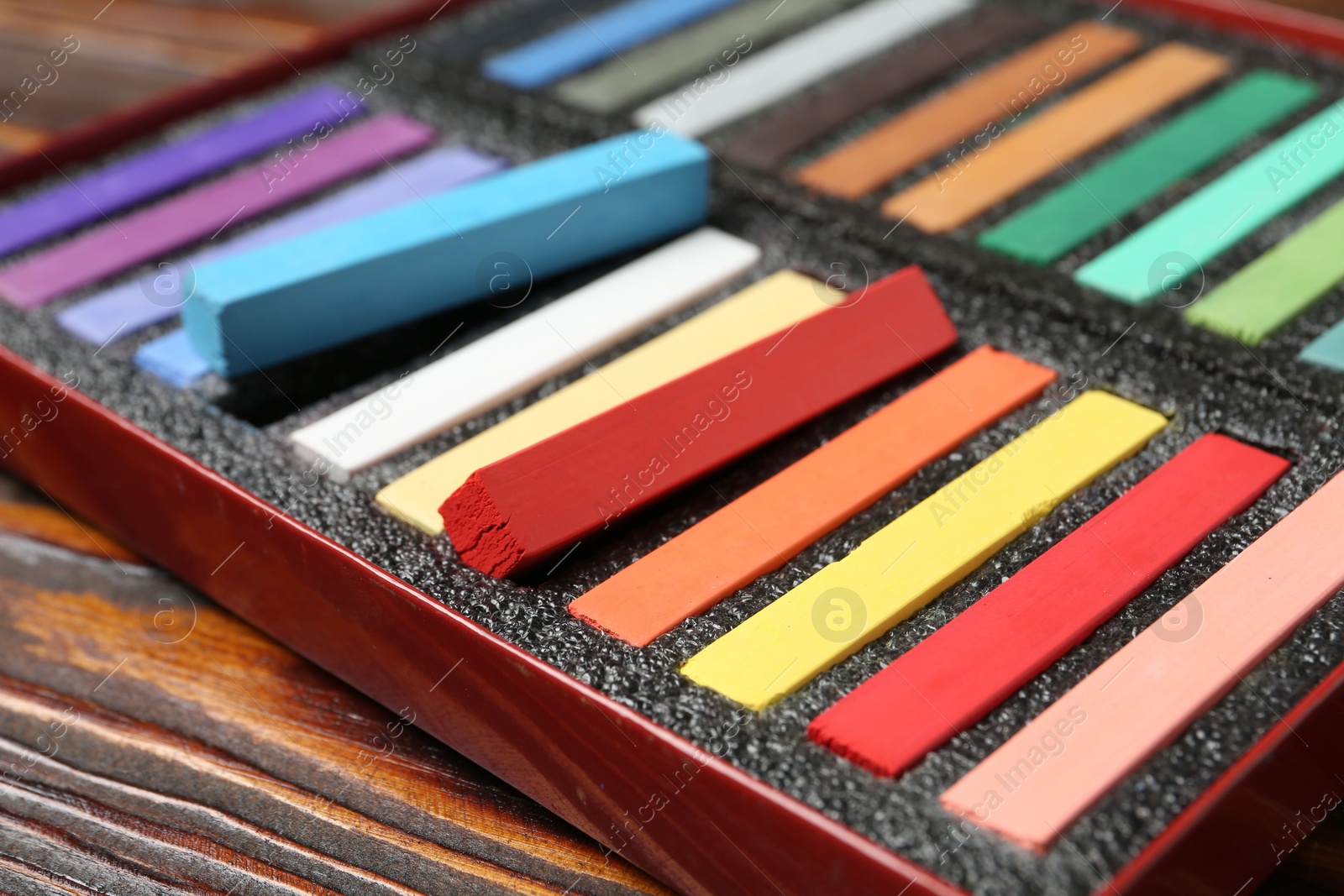 Set of colorful chalk pastels on wooden table, closeup Photo of Set of colorful chalk pastels on wooden table, closeup
