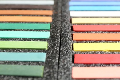 Photo of Set of colorful chalk pastels as background, closeup