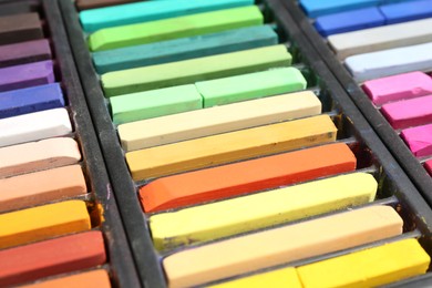 Photo of Set of colorful chalk pastels as background, closeup