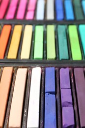 Photo of Set of colorful chalk pastels as background, closeup