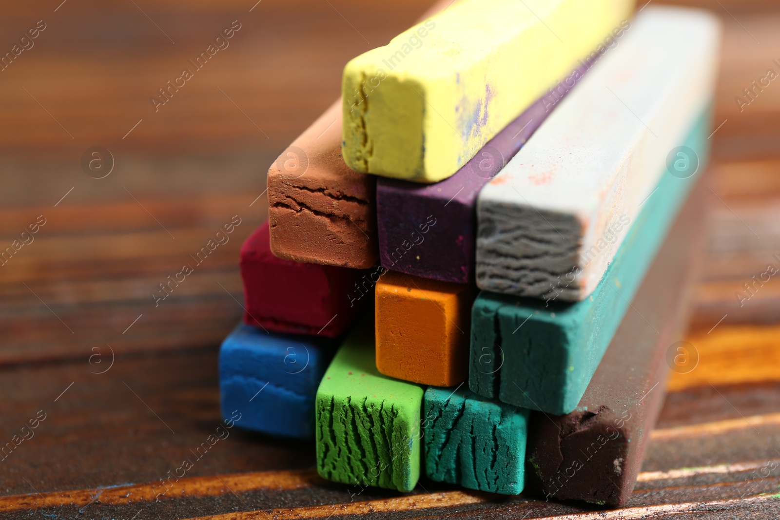 Colorful chalk pastels on wooden table, closeup Photo of Colorful chalk pastels on wooden table, closeup