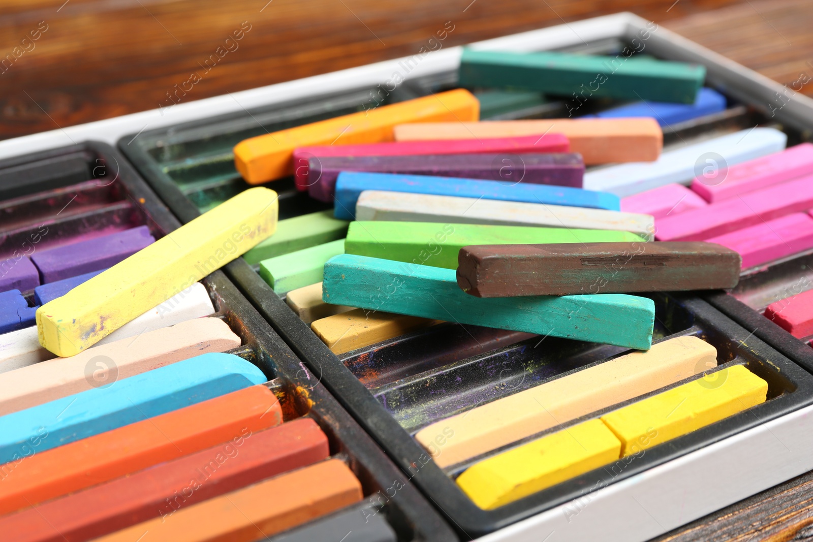 Set of colorful chalk pastels on wooden table, closeup Photo of Set of colorful chalk pastels on wooden table, closeup