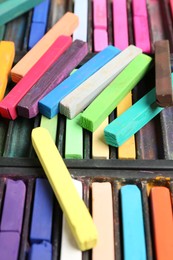 Photo of Set of colorful chalk pastels as background, closeup