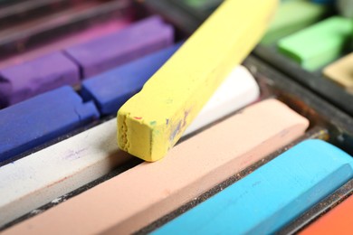 Photo of Set of colorful chalk pastels as background, closeup