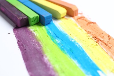 Photo of Colorful chalk pastels on white background, closeup