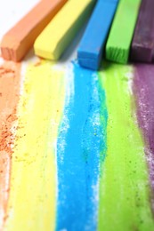 Photo of Colorful chalk pastels on white background, closeup