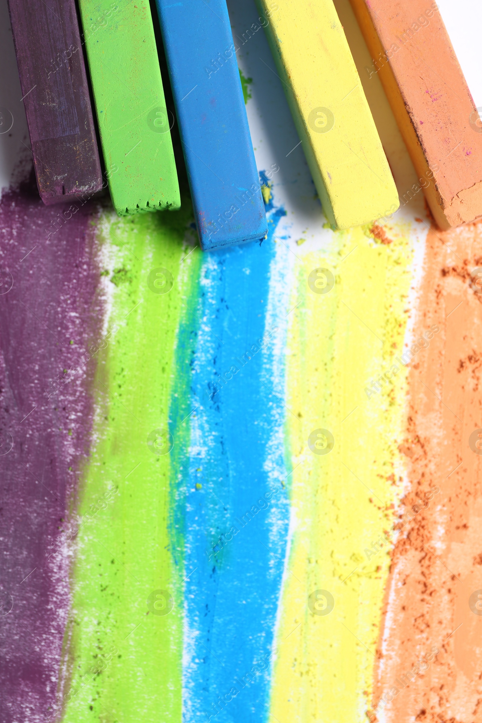Colorful chalk pastels on white background, flat lay Photo of Colorful chalk pastels on white background, flat lay