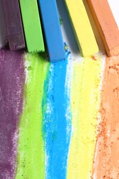 Photo of Colorful chalk pastels on white background, flat lay