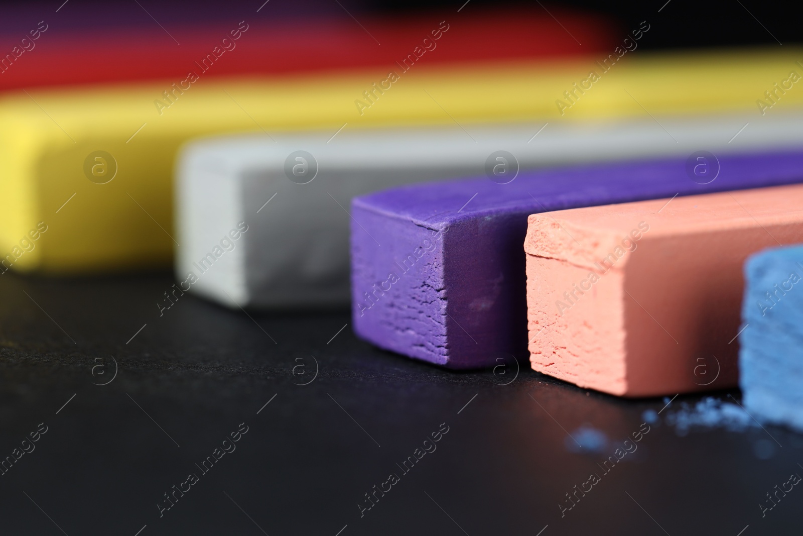 Colorful chalk pastels on black background, closeup Photo of Colorful chalk pastels on black background, closeup