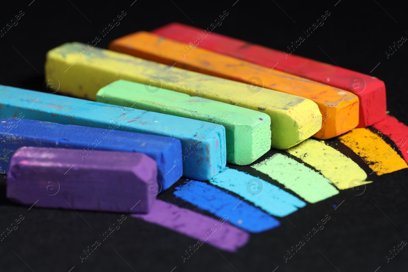 Colorful chalk pastels on black background, closeup Photo of Colorful chalk pastels on black background, closeup
