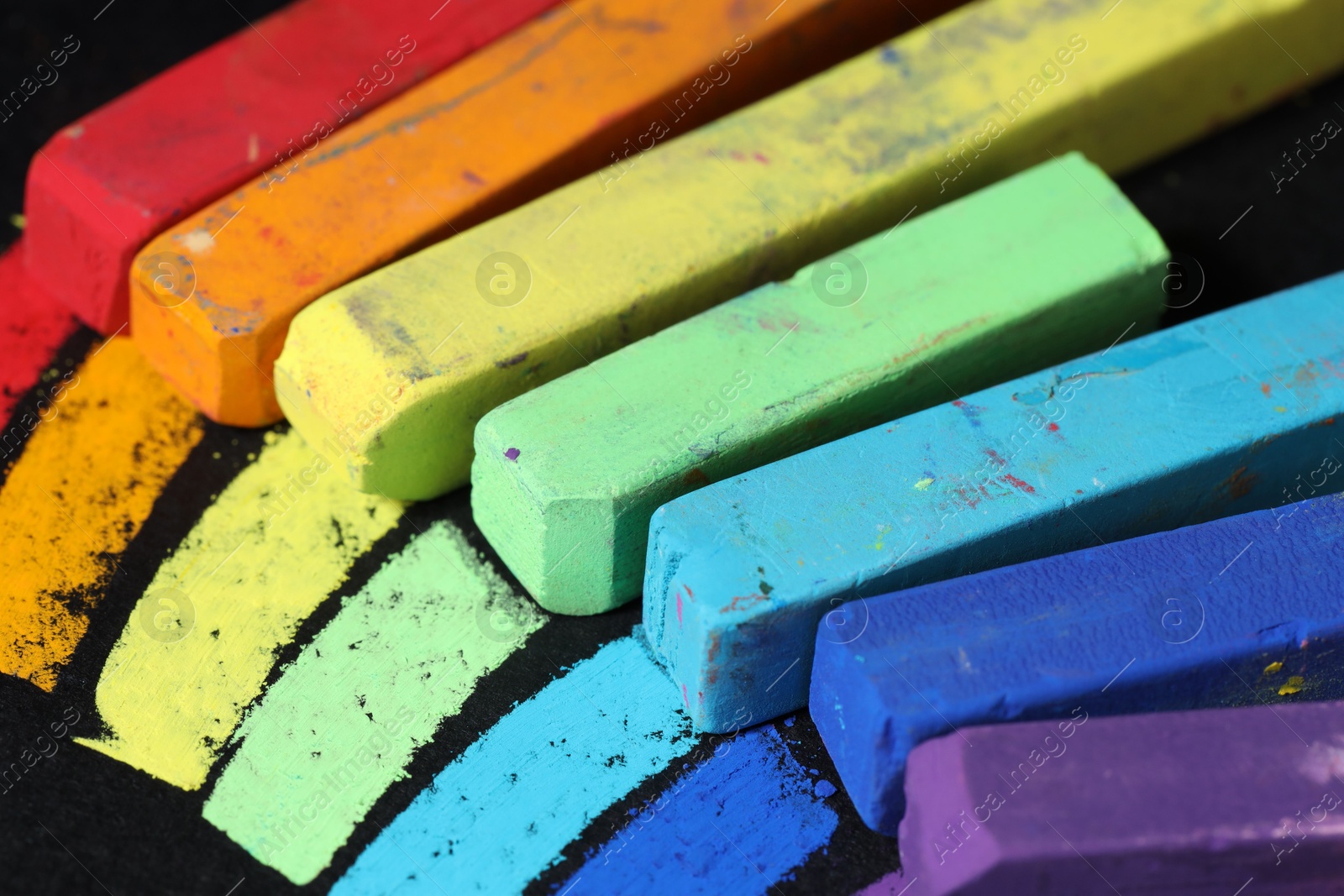 Colorful chalk pastels on black background, closeup Photo of Colorful chalk pastels on black background, closeup