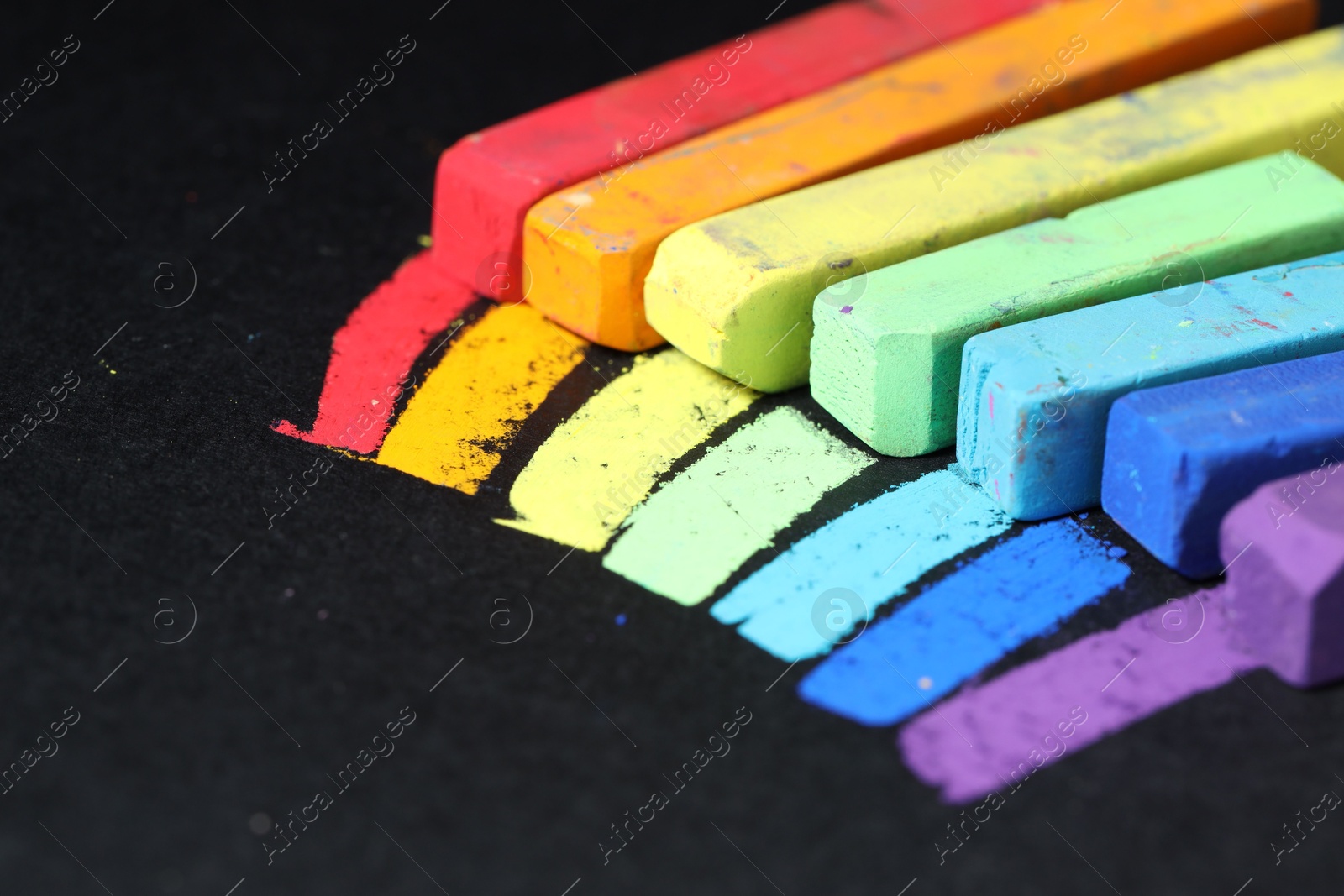 Colorful chalk pastels on black background, closeup Photo of Colorful chalk pastels on black background, closeup