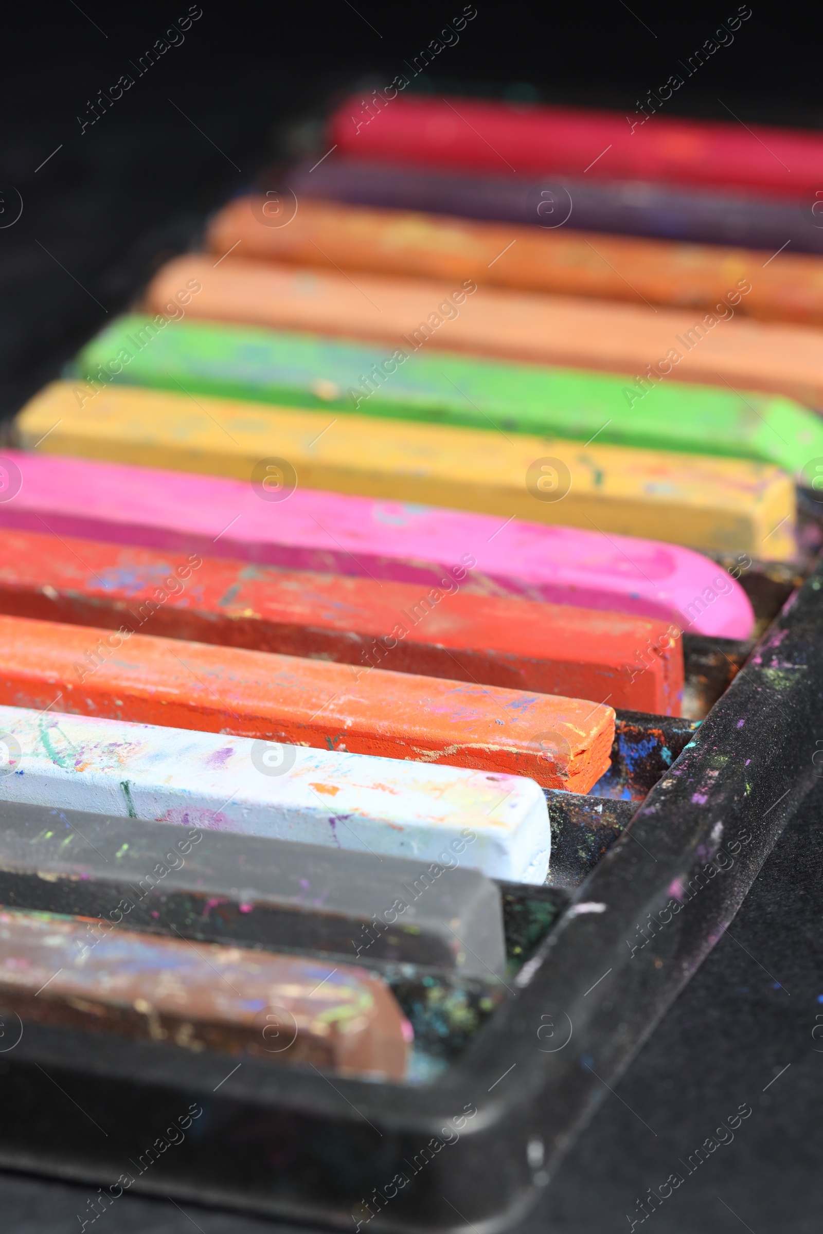 Set of colorful chalk pastels on black background, closeup Photo of Set of colorful chalk pastels on black background, closeup