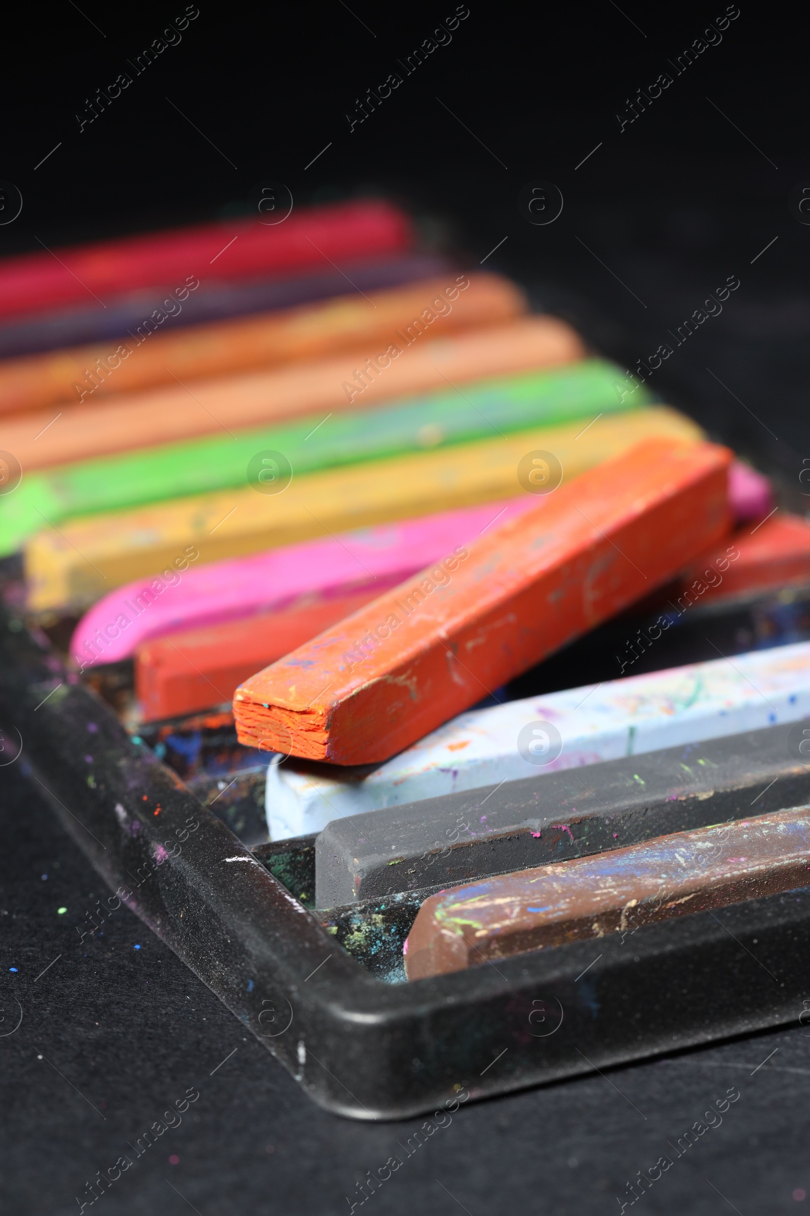 Set of colorful chalk pastels on black background, closeup Photo of Set of colorful chalk pastels on black background, closeup