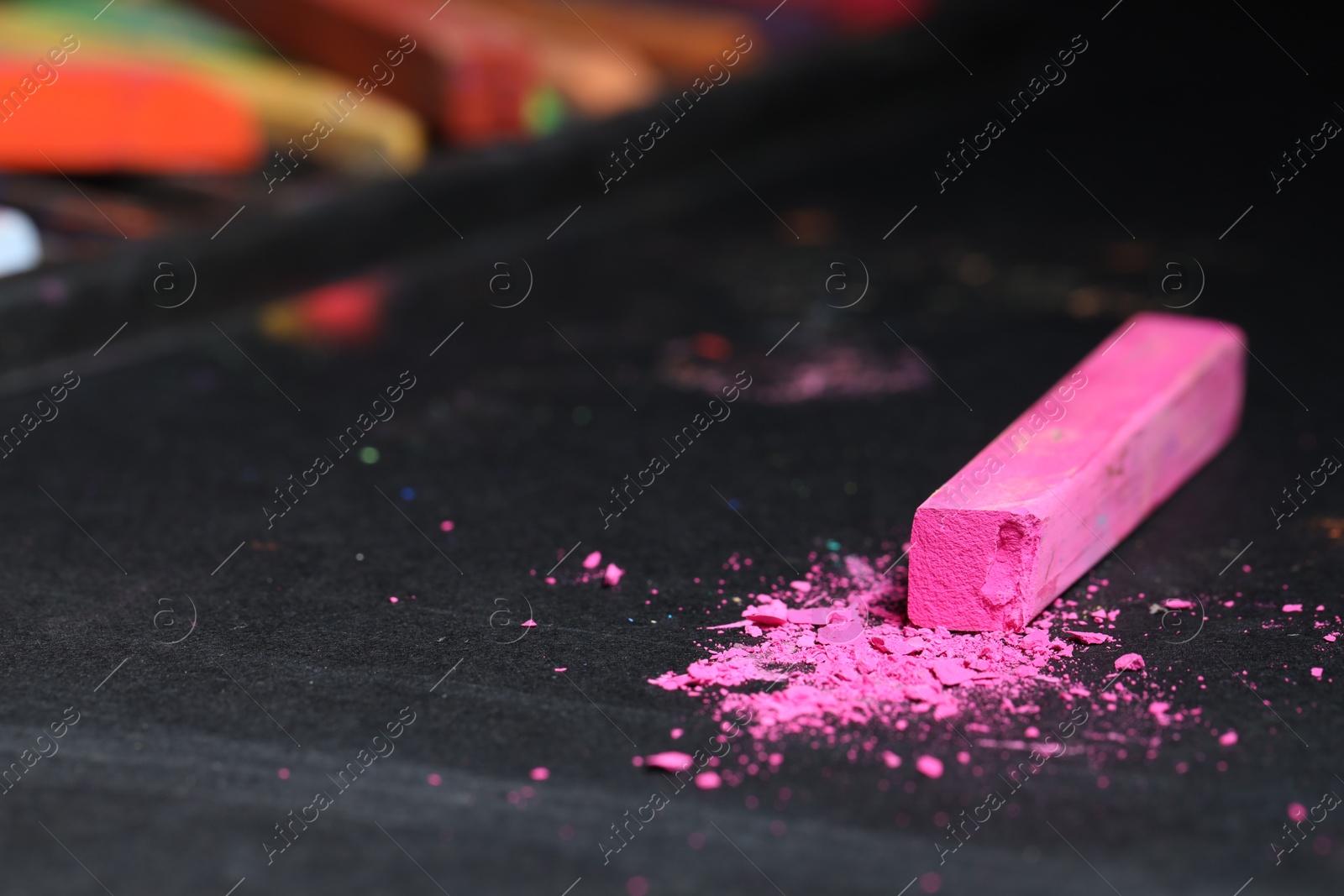 Pink chalk pastel on black table, closeup Photo of Pink chalk pastel on black table, closeup