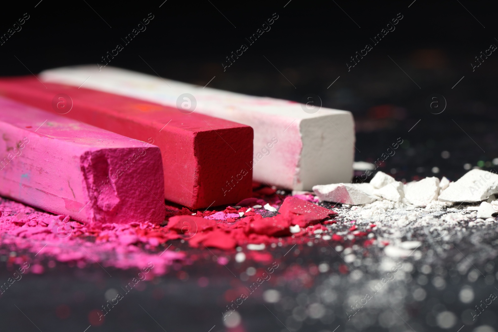 Colorful chalk pastels on black background, closeup Photo of Colorful chalk pastels on black background, closeup