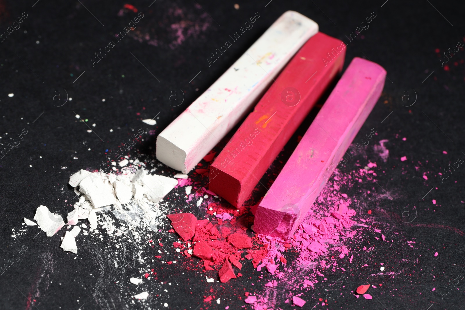 Colorful chalk pastels on black background, closeup Photo of Colorful chalk pastels on black background, closeup