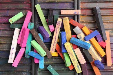 Photo of Set of colorful chalk pastels as background, closeup