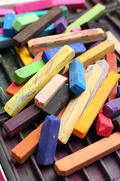 Photo of Set of colorful chalk pastels as background, closeup
