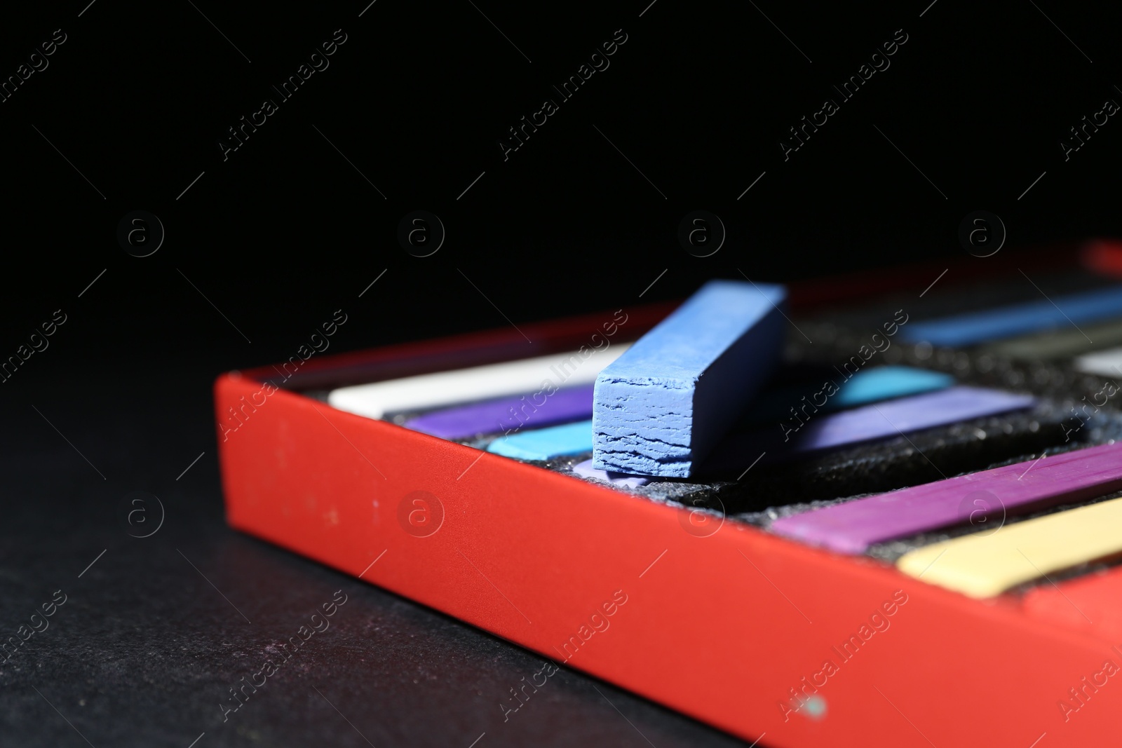 Many colorful chalk pastels on black background, closeup. Space for text Photo of Many colorful chalk pastels on black background, closeup. Space for text