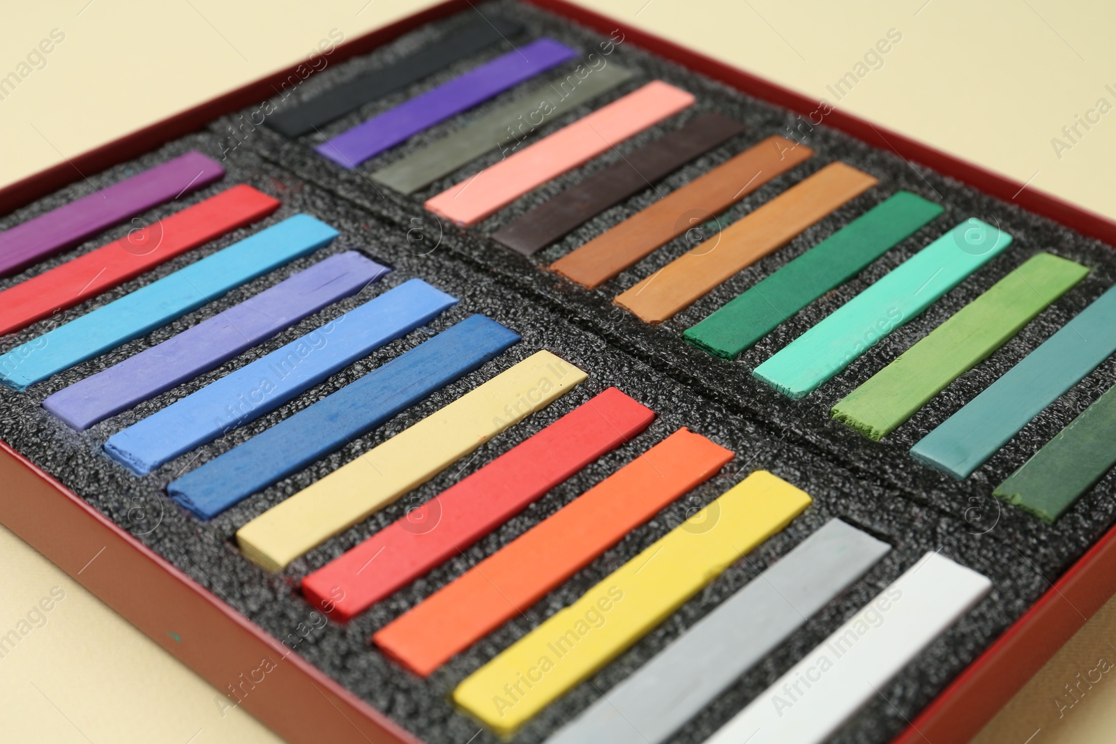 Set of colorful chalk pastels on beige background, closeup Photo of Set of colorful chalk pastels on beige background, closeup
