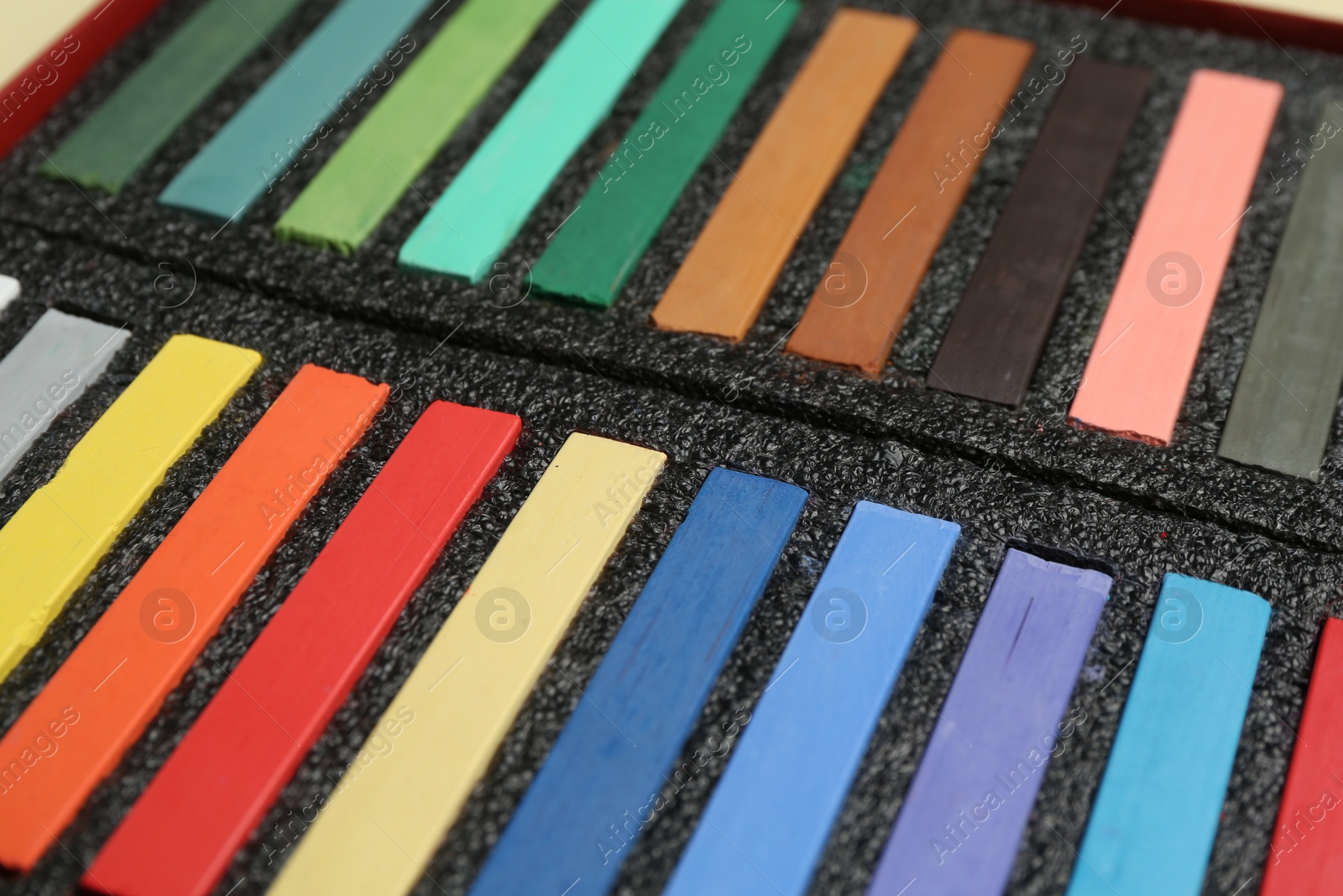 Photo of Set of colorful chalk pastels as background, closeup