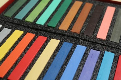Photo of Set of colorful chalk pastels as background, closeup