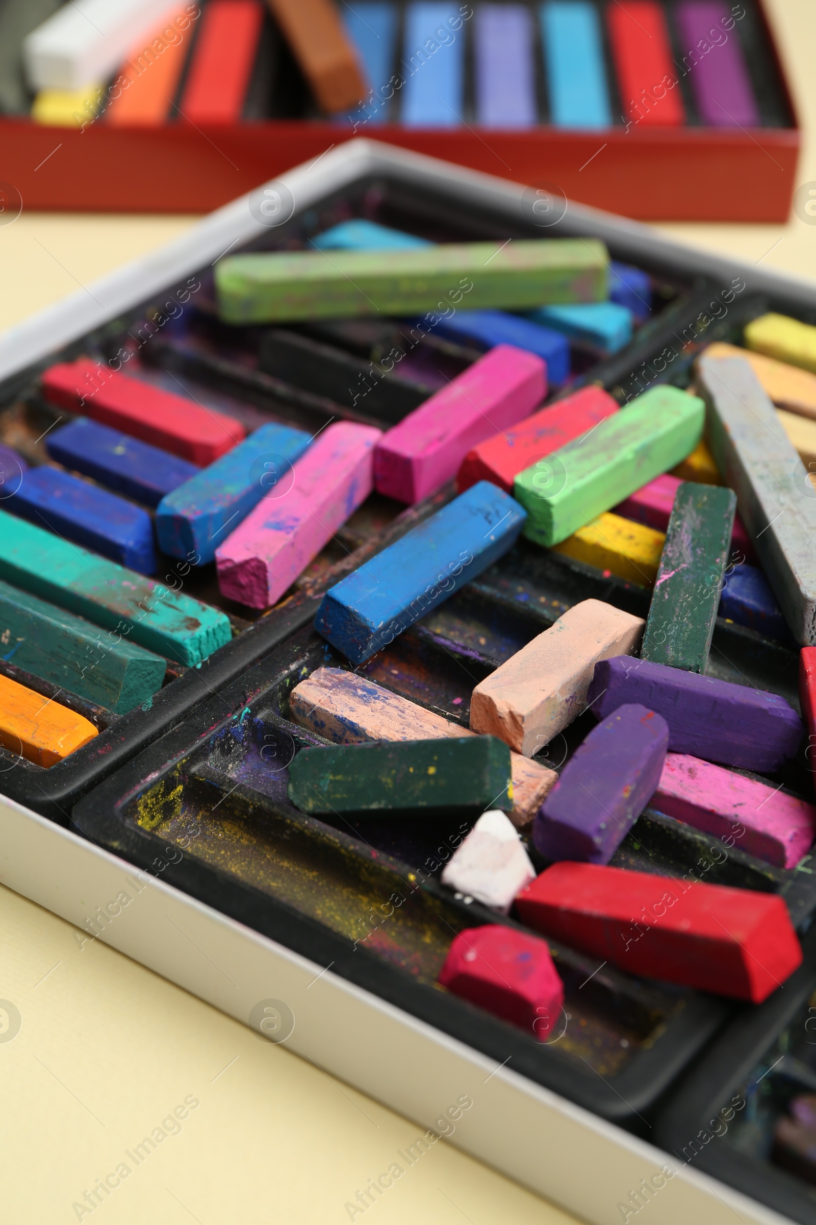 Set of colorful chalk pastels on beige background, closeup Photo of Set of colorful chalk pastels on beige background, closeup
