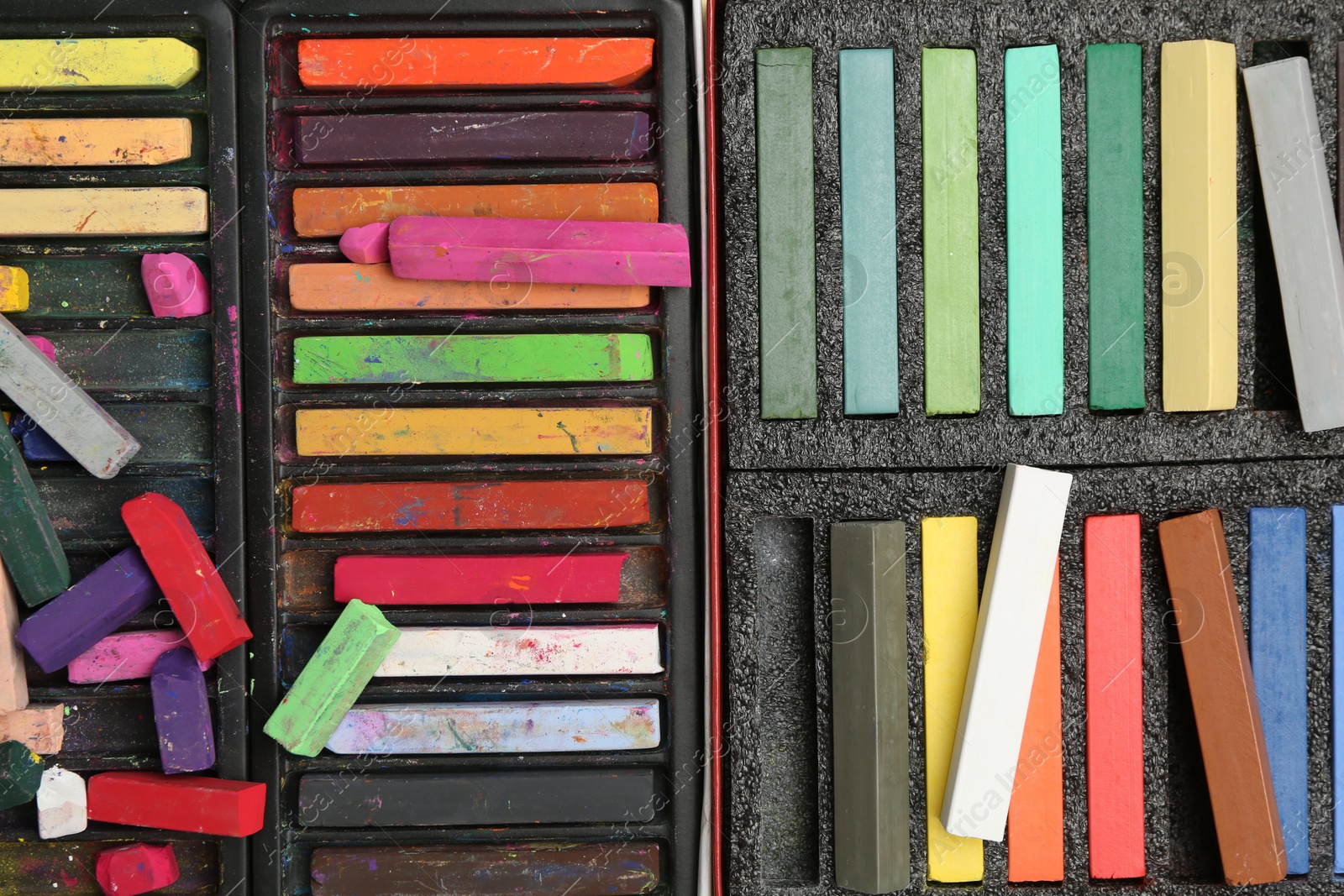 Photo of Set of colorful chalk pastels as background, closeup