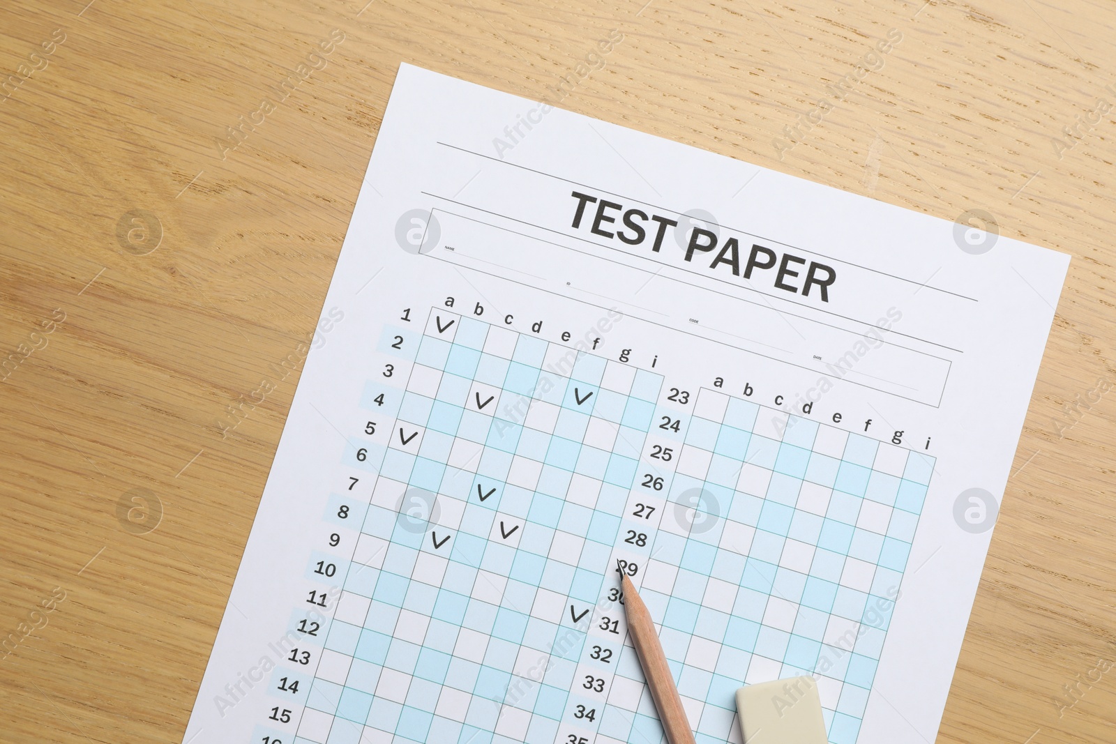 Photo of Answer sheet, eraser and pencil on wooden table, flat lay. Student passing exam