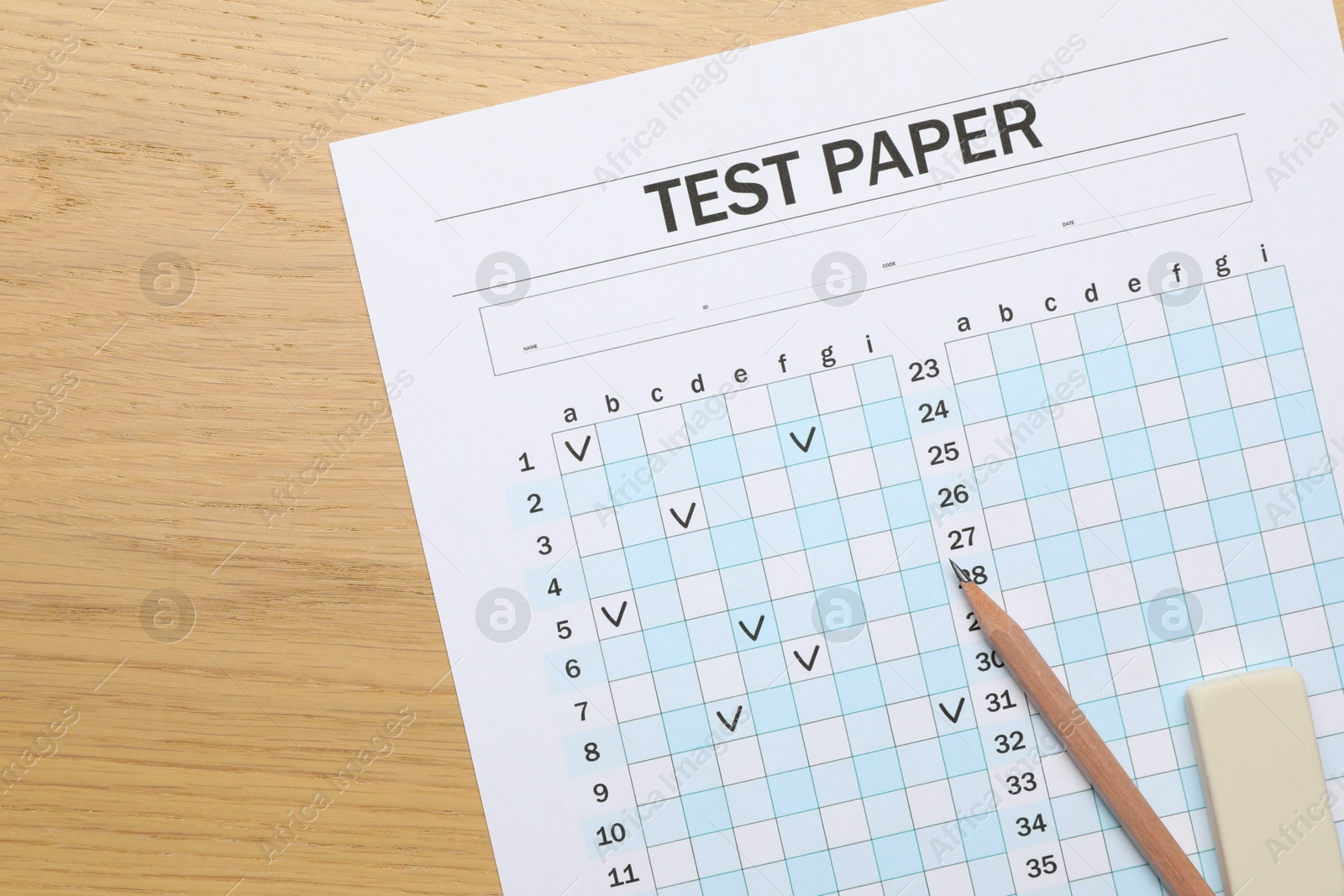 Photo of Answer sheet, eraser and pencil on wooden table, flat lay. Student passing exam