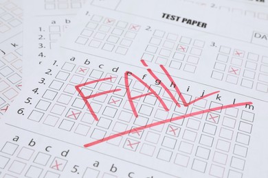 Photo of Word Fail written with red marker on answer sheet, closeup. Student passing exam