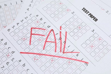 Photo of Word Fail written with red marker on answer sheet, closeup. Student passing exam
