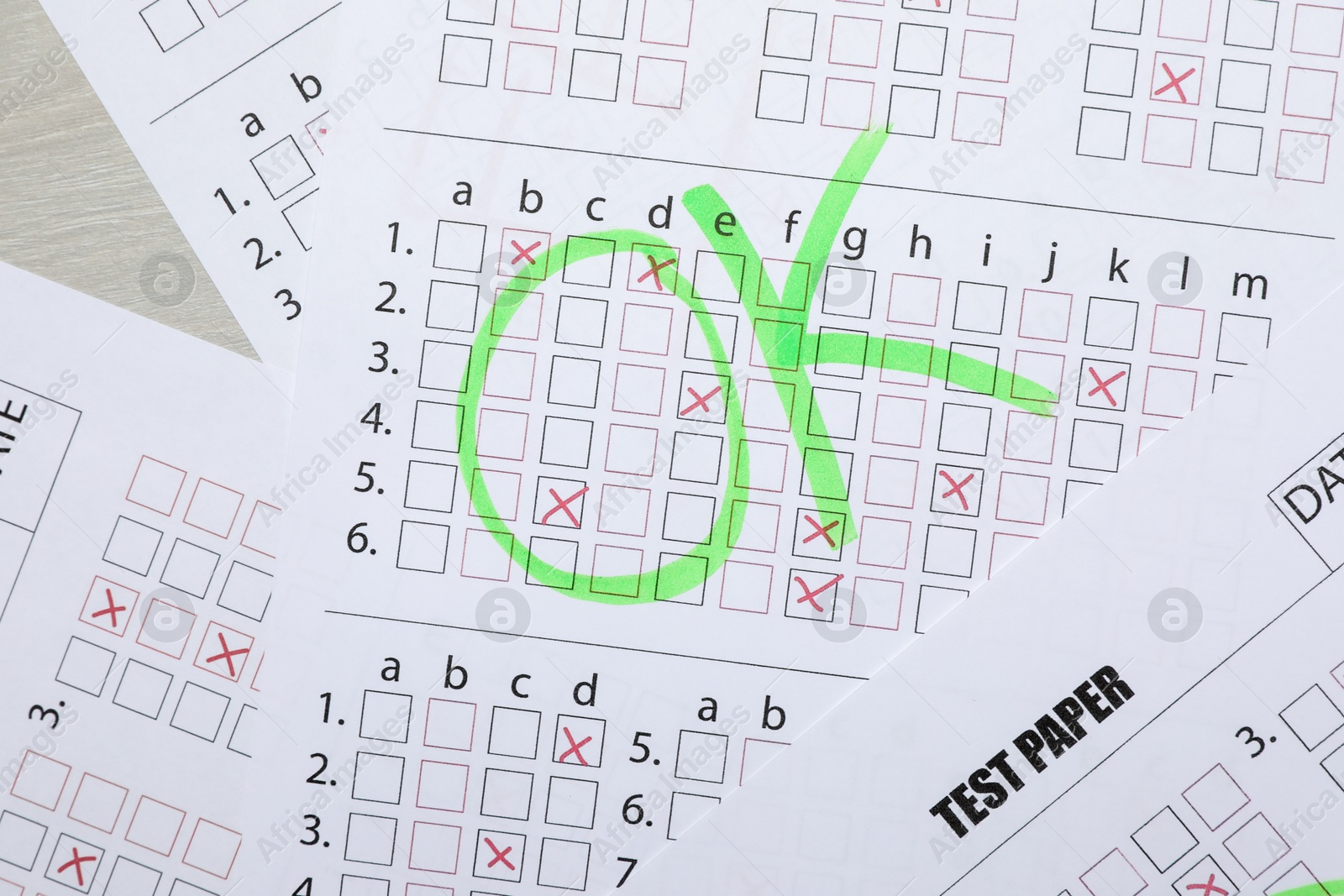 Answer sheets with word Ok on table, top view. Student passing exam Photo of Answer sheets with word Ok on table, top view. Student passing exam