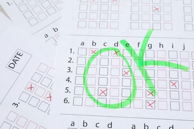 Photo of Answer sheets with word Ok, above view. Student passing exam