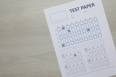 Photo of Student passing exam. Answer sheet on wooden table, top view. Space for text