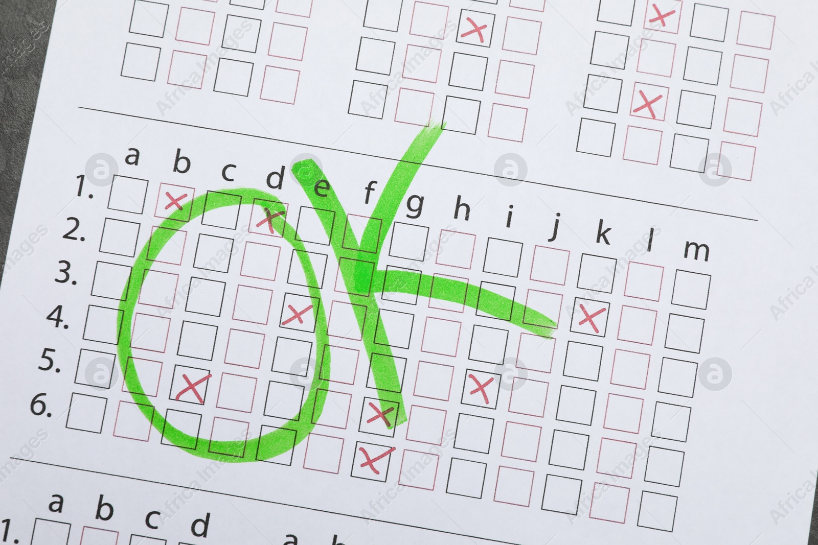 Word OK written with green marker on answer sheet, top view. Student passing exam Photo of Word OK written with green marker on answer sheet, top view. Student passing exam