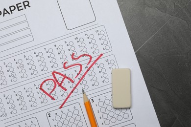 Photo of Answer sheet with word Pass, eraser and pencil on gray textured table, flat lay. Student passing exam